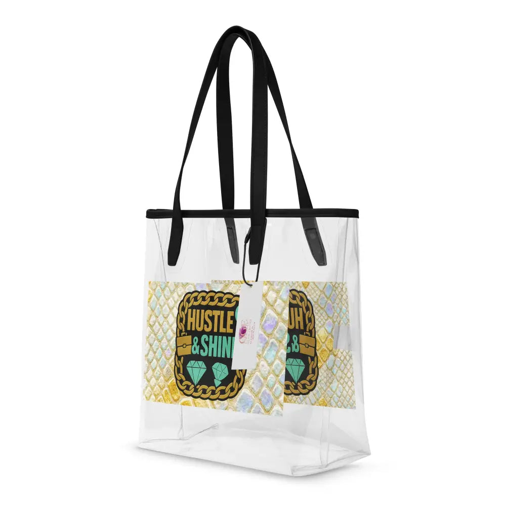 Transparente Tragetasche Hustle & Shine mit schwarzen Griffen und goldenen Snake-Details