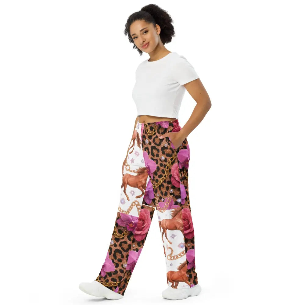 woman wearing Wild Glam Wide Leg Pants with horse, chains, orchid and leopard print standing in white top and sneakers
