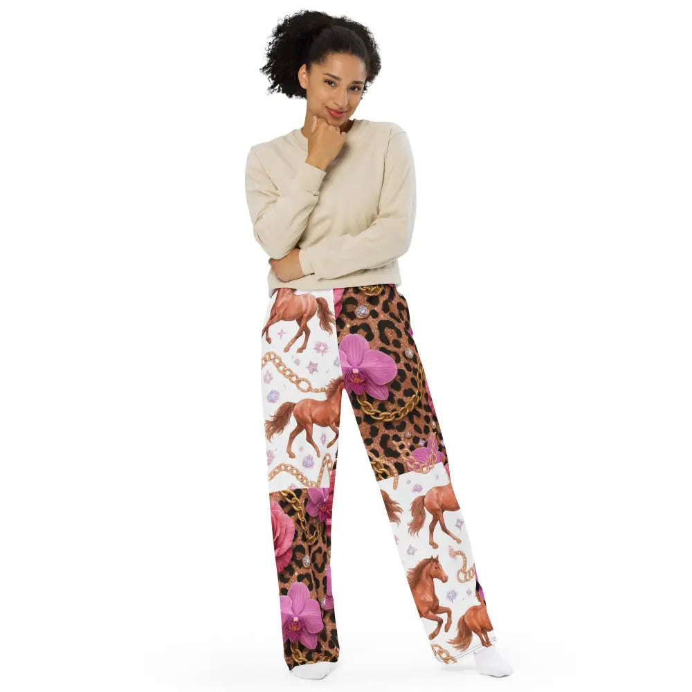Woman wearing Wild Glam Wide Leg Pants with horse, chains, orchid, and leopard print design